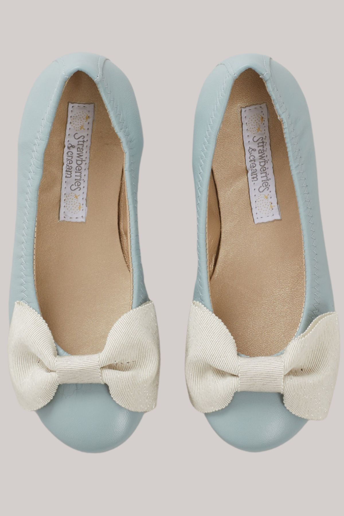 Ballerina_Bow_-_Pastel_Blue_-_Strawberries_Cream_-_Ingrid_Lewis_-_Designer 
Pair of light blue flats with white bows.