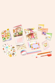 Djeco - Tinou Stationary Cabinet - Strawberries & Cream - Ingrid Lewis - Designer
Collection of stationery items including notebooks, stickers, and pens.