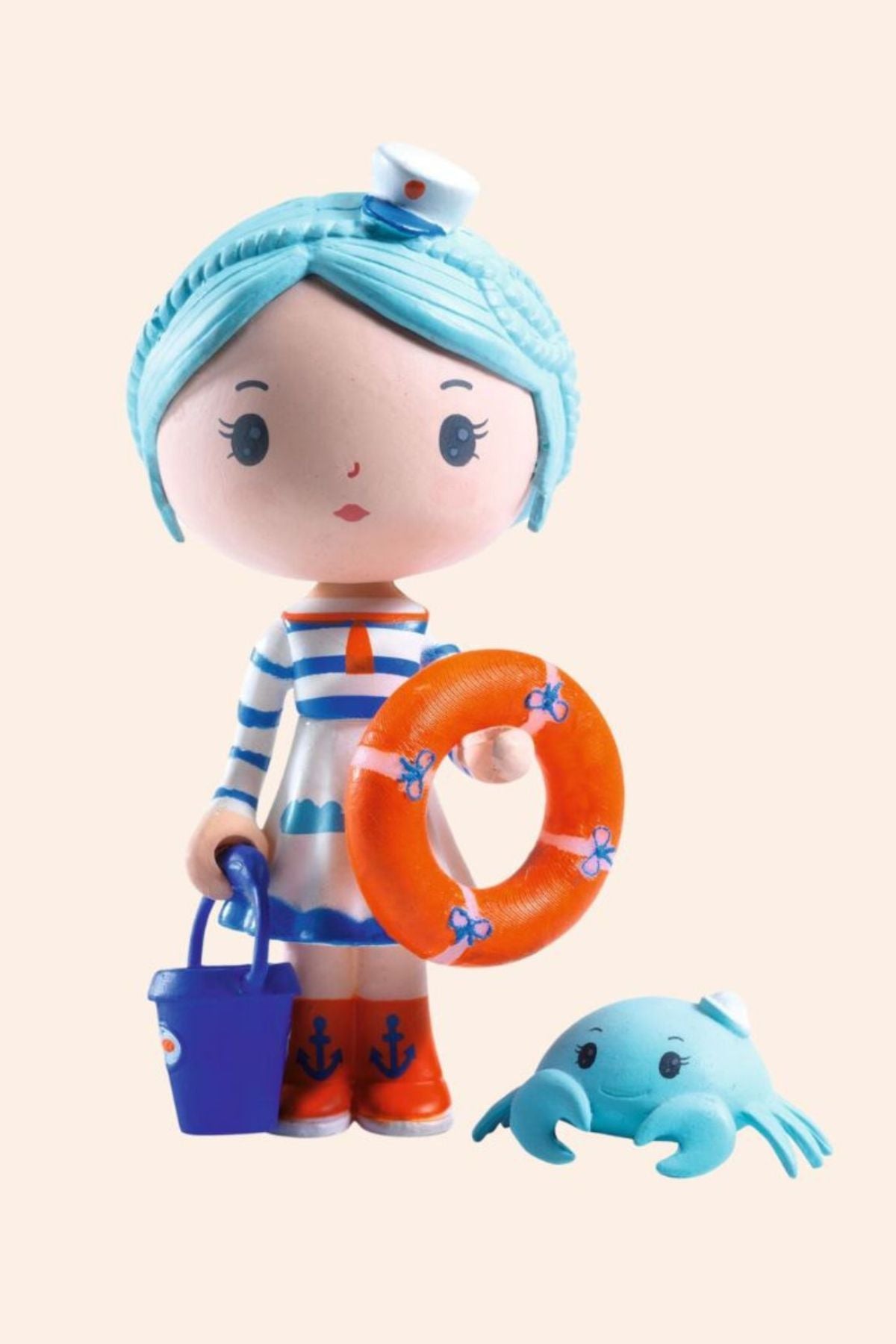 Djeco - Tinyly - Marinette & Scouic doll - Strawberries & Cream - Collectables - Friendship - Dolls - Ingrid Lewis - Designer 
Toy figure with blue hair, striped outfit, and life preserver.