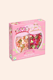 Pink packaging of a tiara set with two heart-shaped boxes on a white background