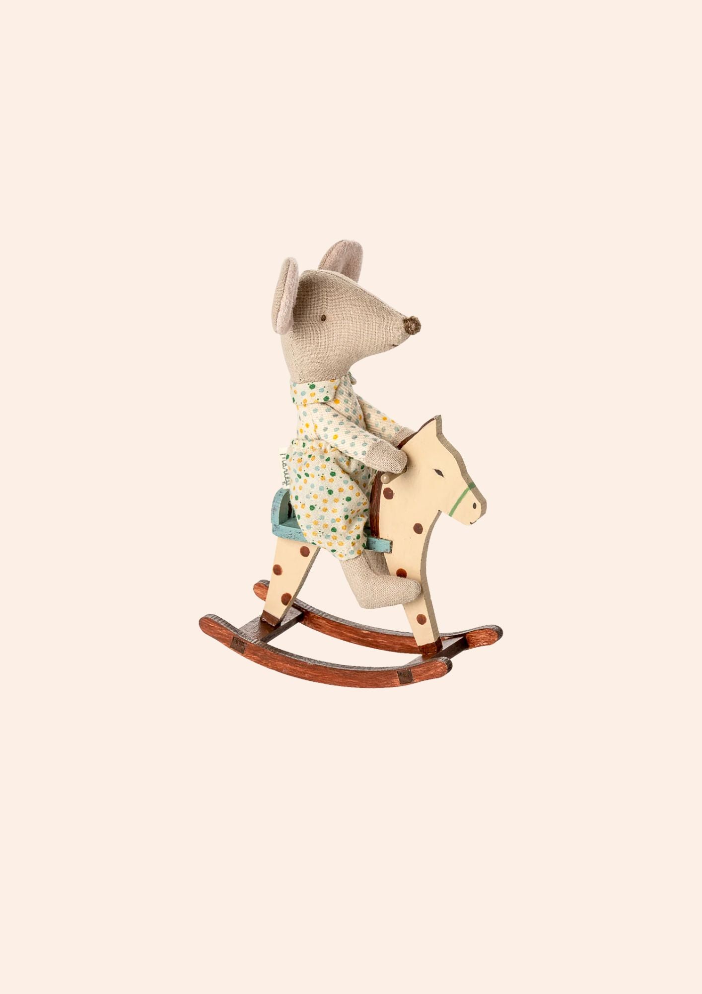 Riding mouse toy on a rocking horse with a neutral background