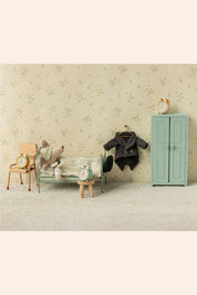 Maileg - Wedding Suit - Dad Mouse - Strawberries & Cream - Ingrid Lewis - Designer 
Miniature bedroom setup with bed, chair, wardrobe, and toys against a floral wallpapered wall.