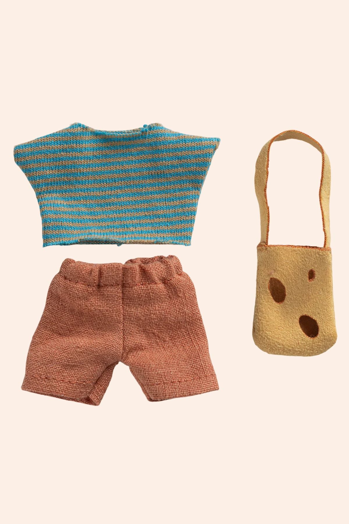 Knitted outfit with blue top and brown shorts, accompanied by a small bag on a beige background