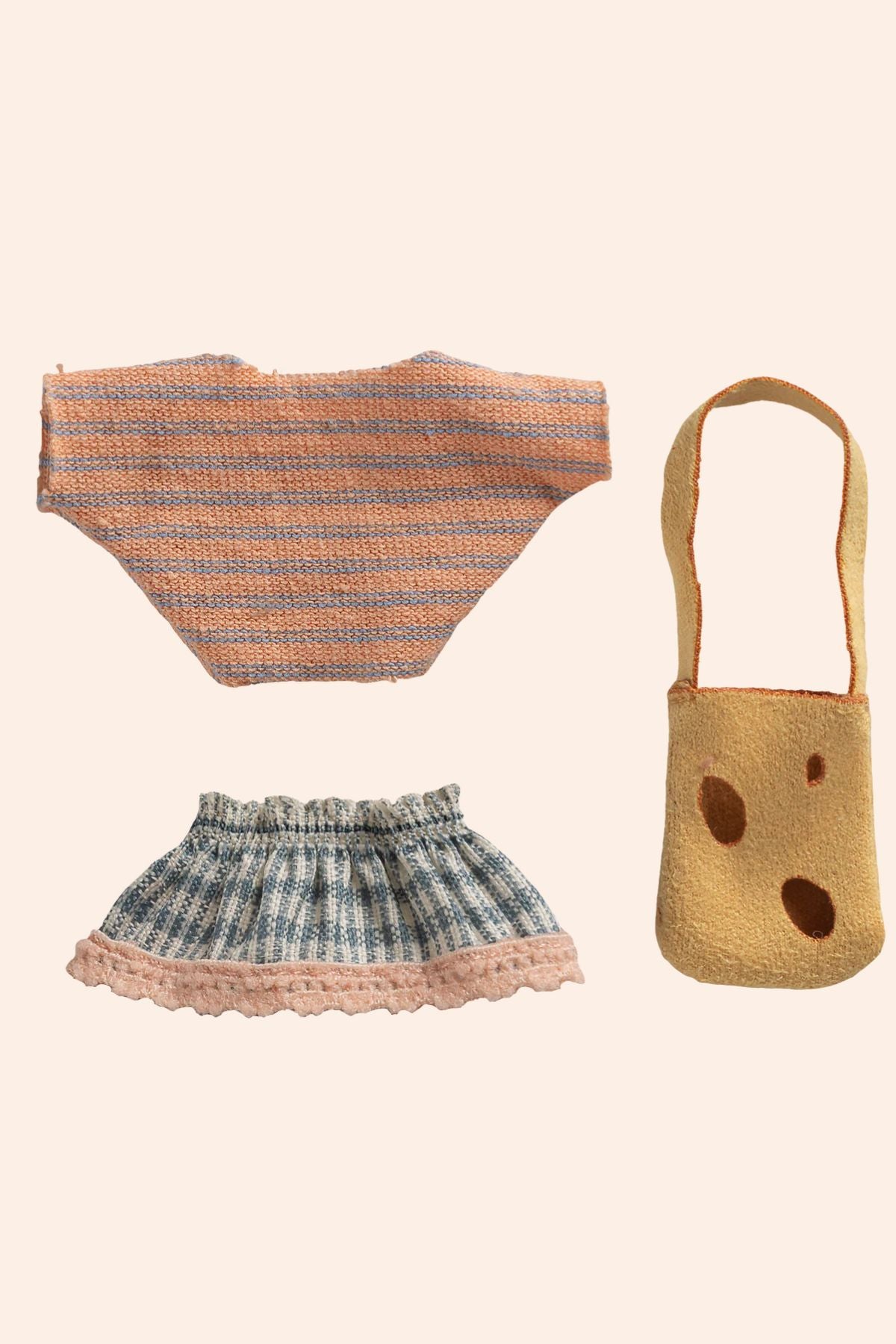 Set of knitted items including a top, skirt, and bag on a beige background