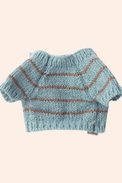 Knitted blue sweater with brown stripes on a beige background