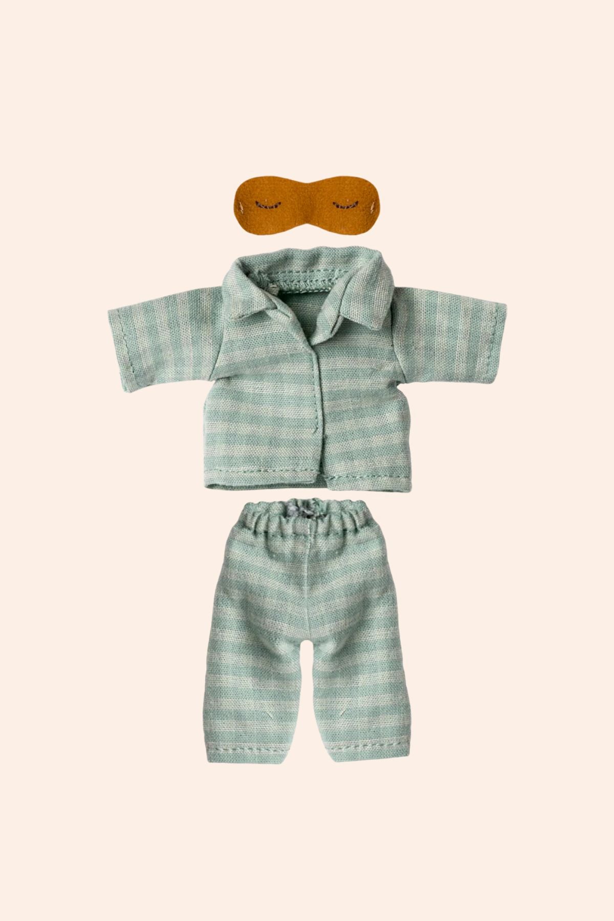 Green plaid shirt and pants set with a mask on a beige background