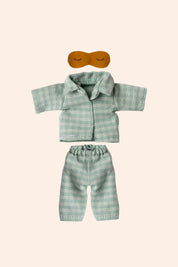 Green plaid shirt and pants set with a mask on a beige background