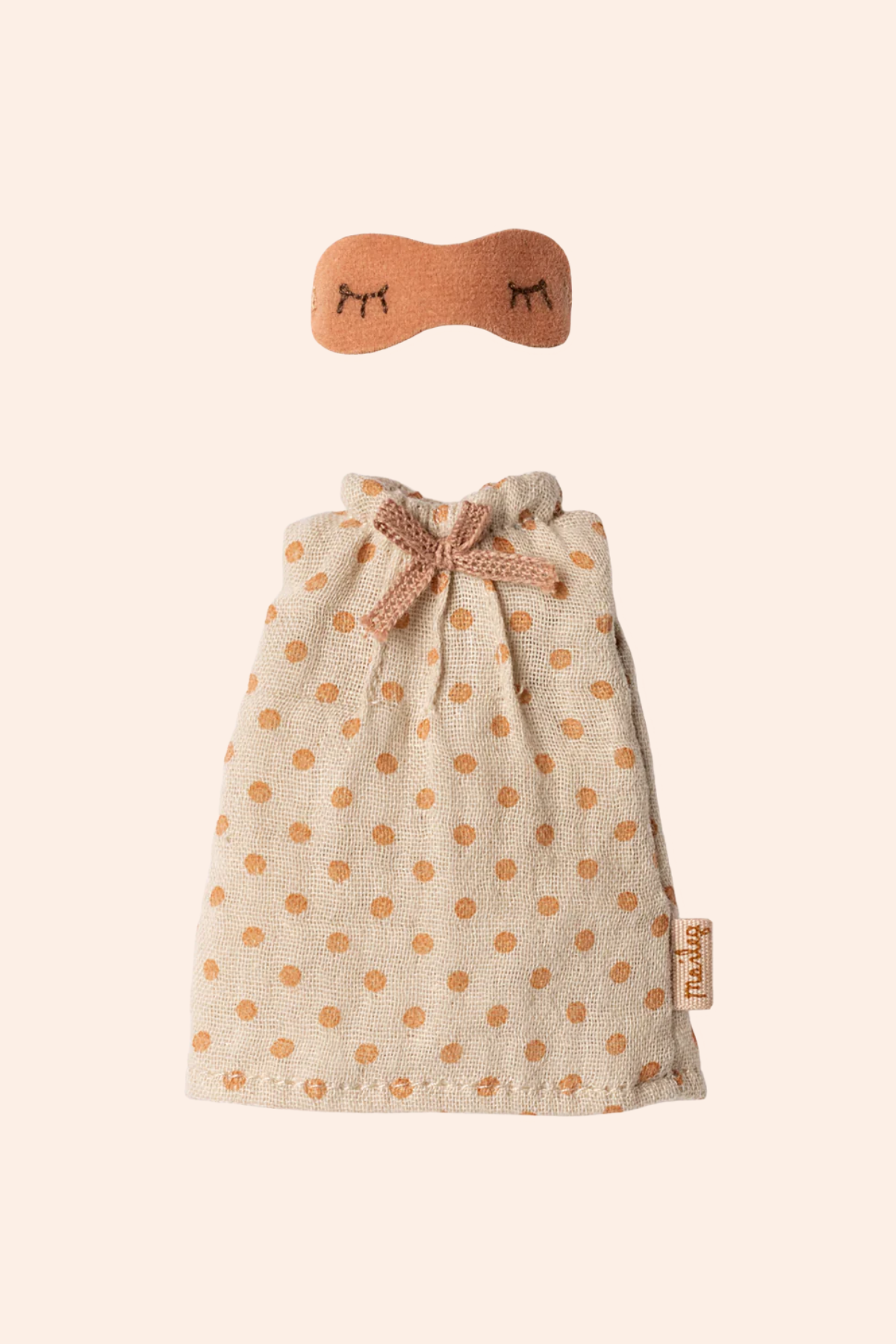 maileg doll outfit with polka dot dress and headband on a beige background